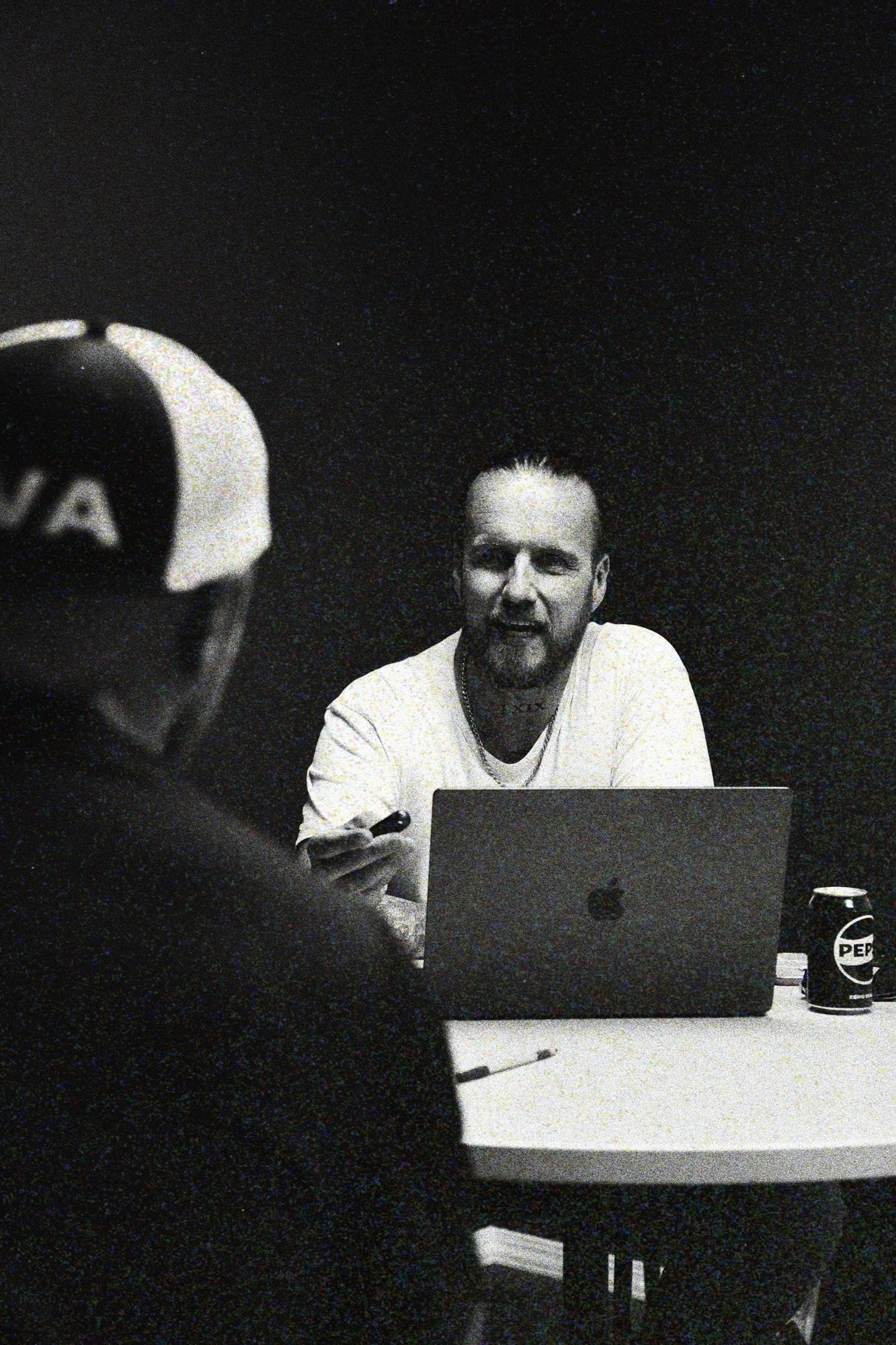 Corey Jeppesen talking with a client at the table in the bahlr studio